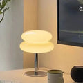 Stylish dimmable glass table lamp providing warm light, perfect for bedroom decor and inviting ambiance.