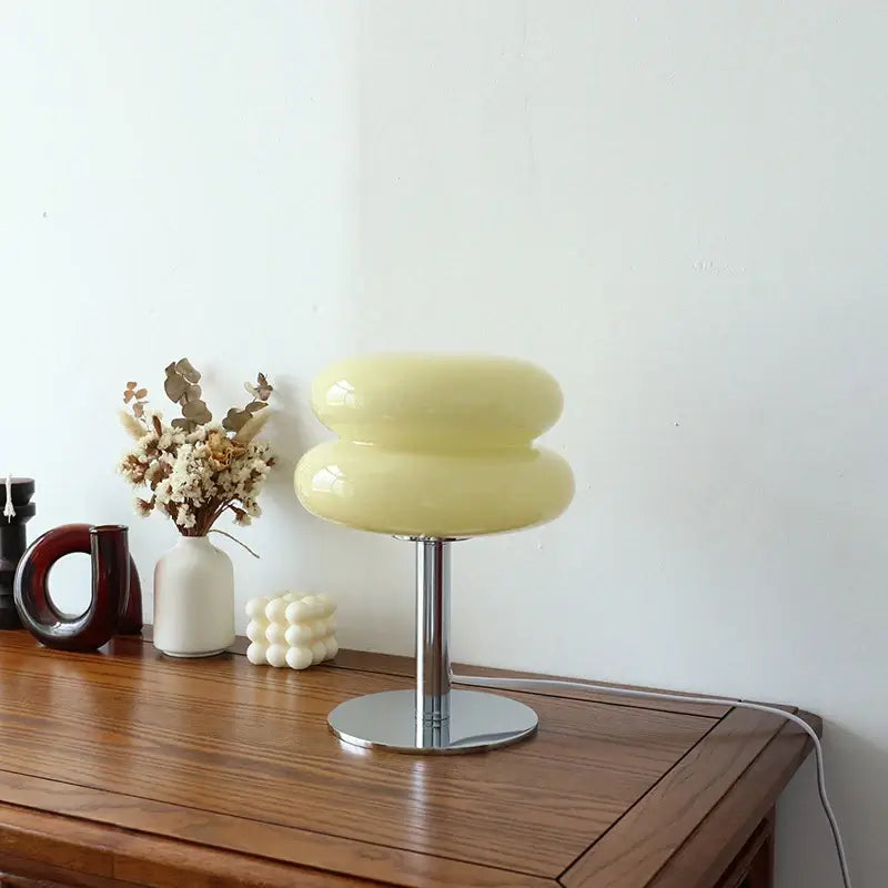 Dimmable Macaron Glass Table Lamp in soft yellow, enhancing bedroom decor with elegance and warm ambiance.