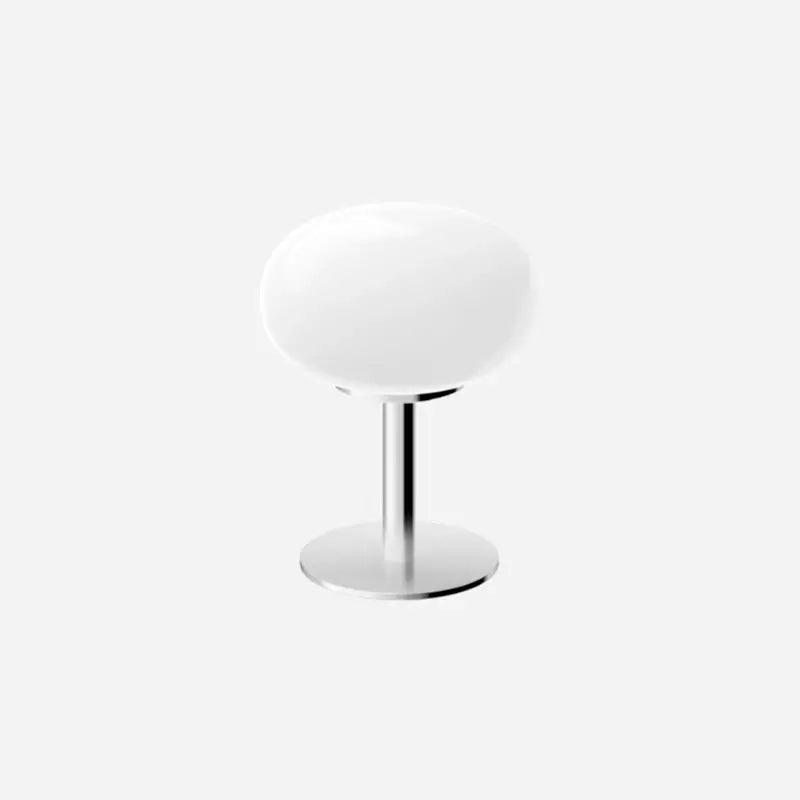 Modern white table lamp with a sleek design and shiny chrome base, ideal for stylish home décor.